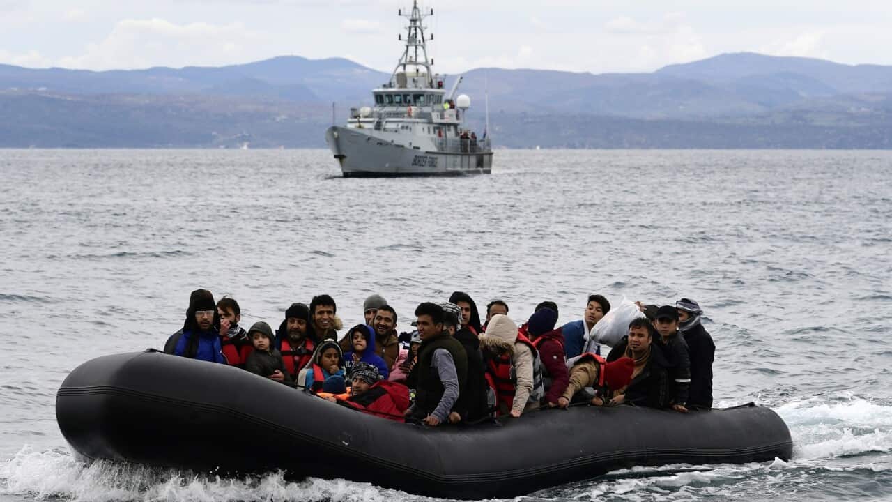 Migrants arrive on a dinghy on the Greek island of Lesbos