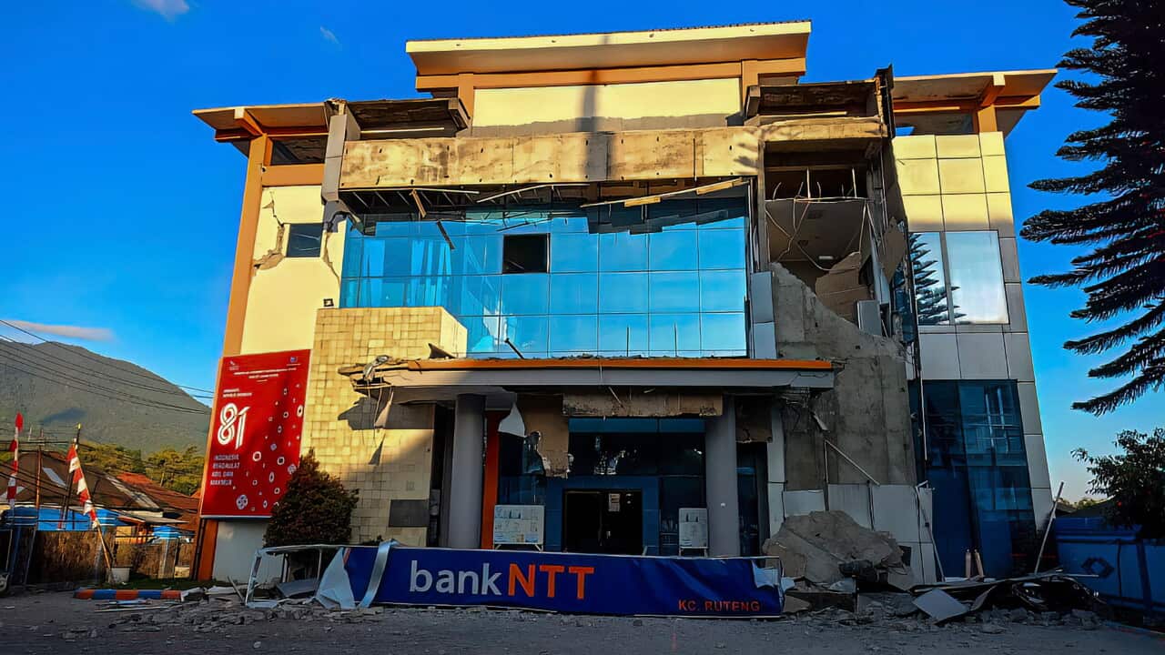 A damaged two-story office building standing in a rural area.