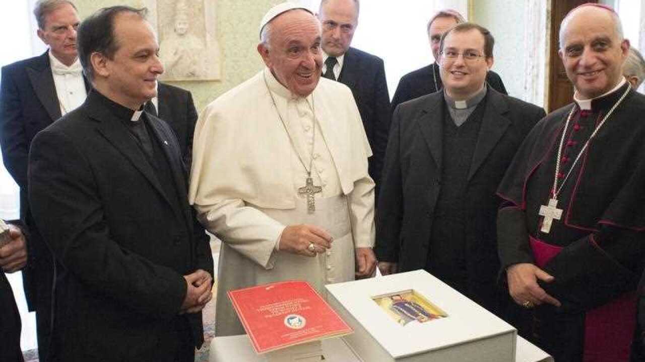 Pope Francis is presented with a Liturgical book containing parts of the Gospel to be used during the Holy Mass at the Vatican