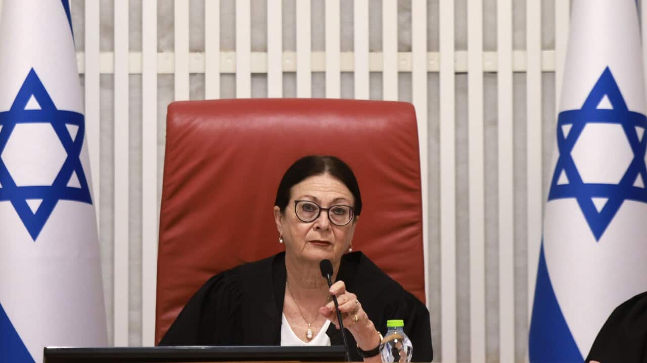 A judge speaks in front of a microphone.