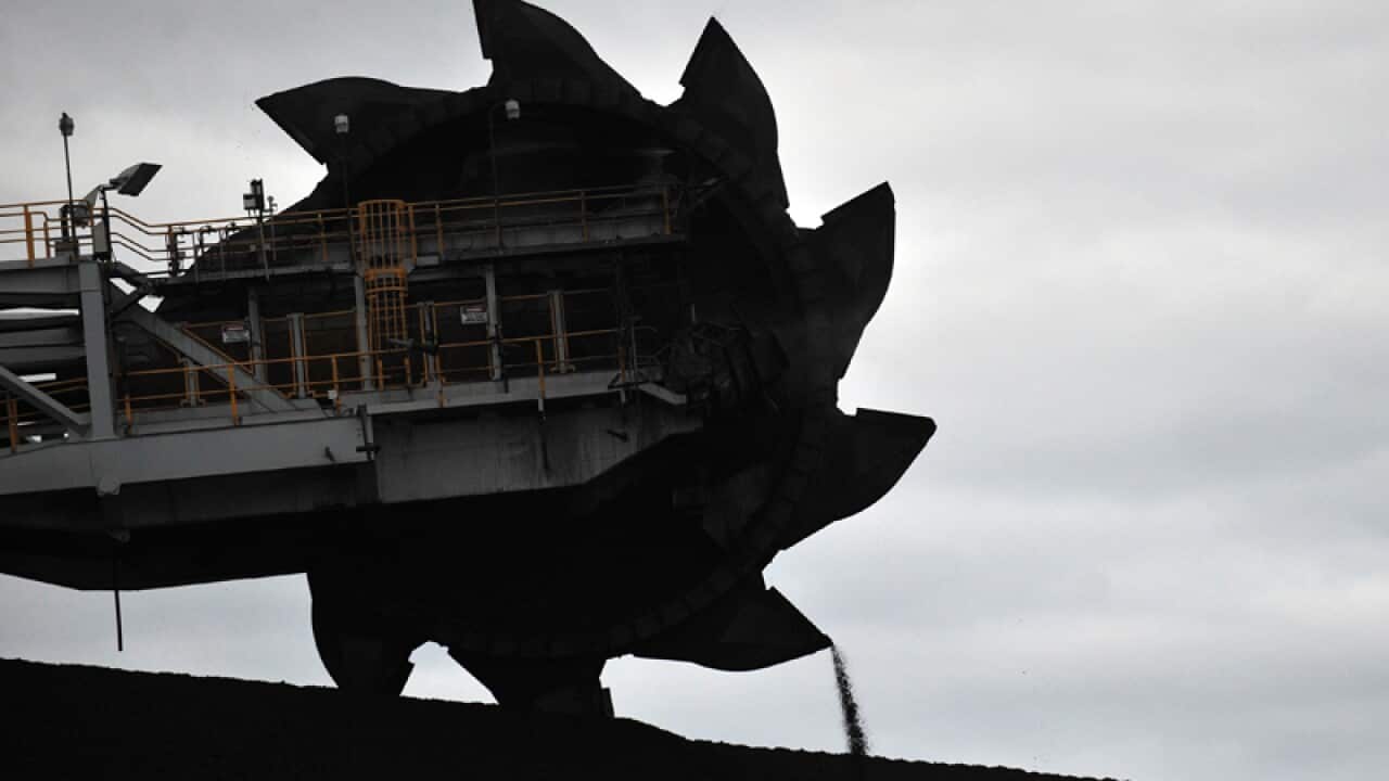 A loader shifts coal