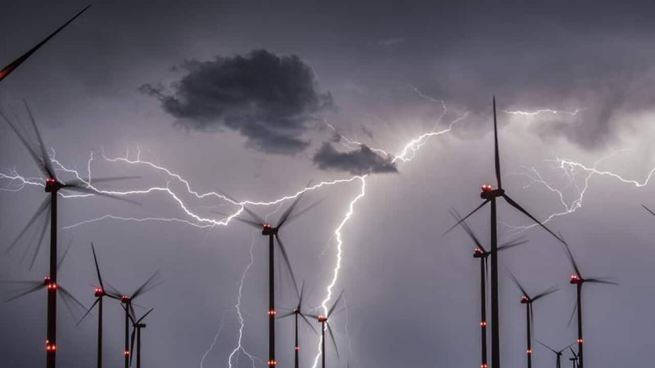 Lightning illuminates the night sky over a wind farm in Germany.