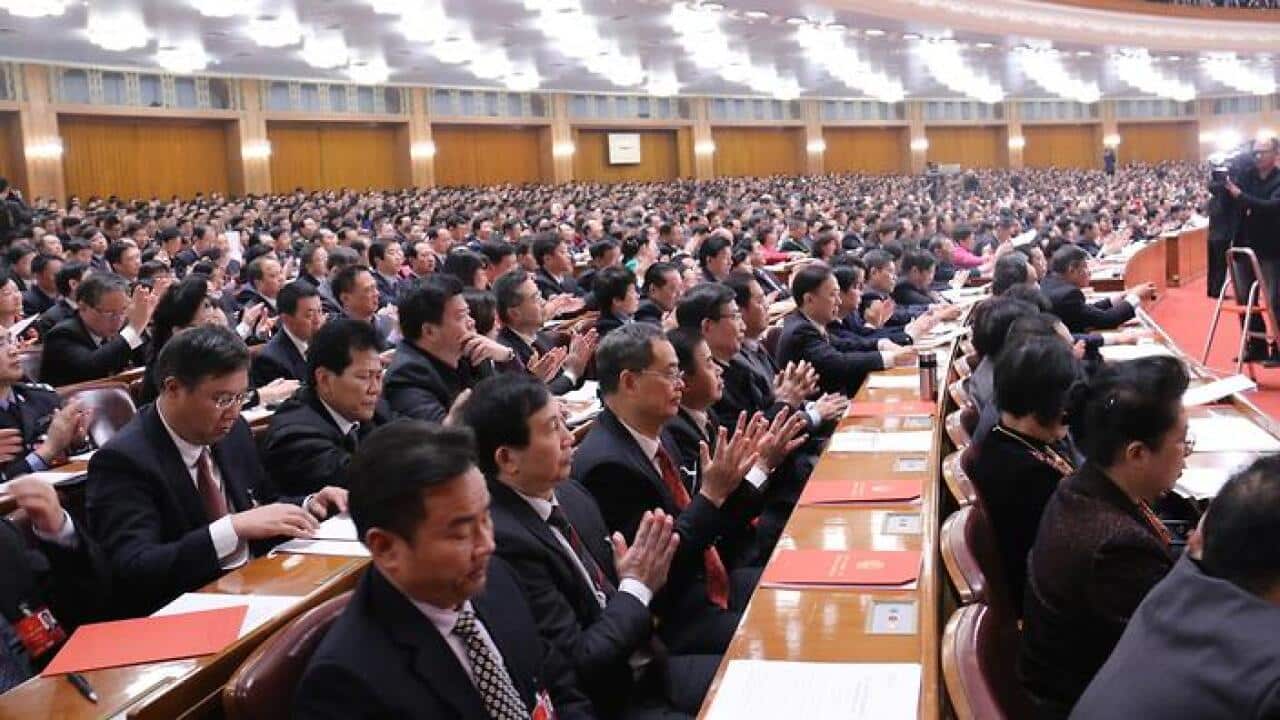 Deputies attend the closing meeting of National People's Congress in Beijing