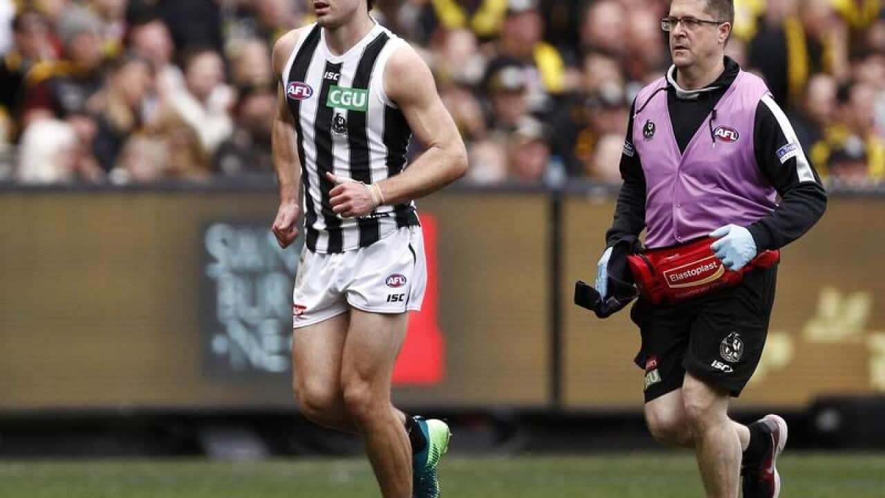 Matthew Scharenberg of the Magpies leaves the ground injured.