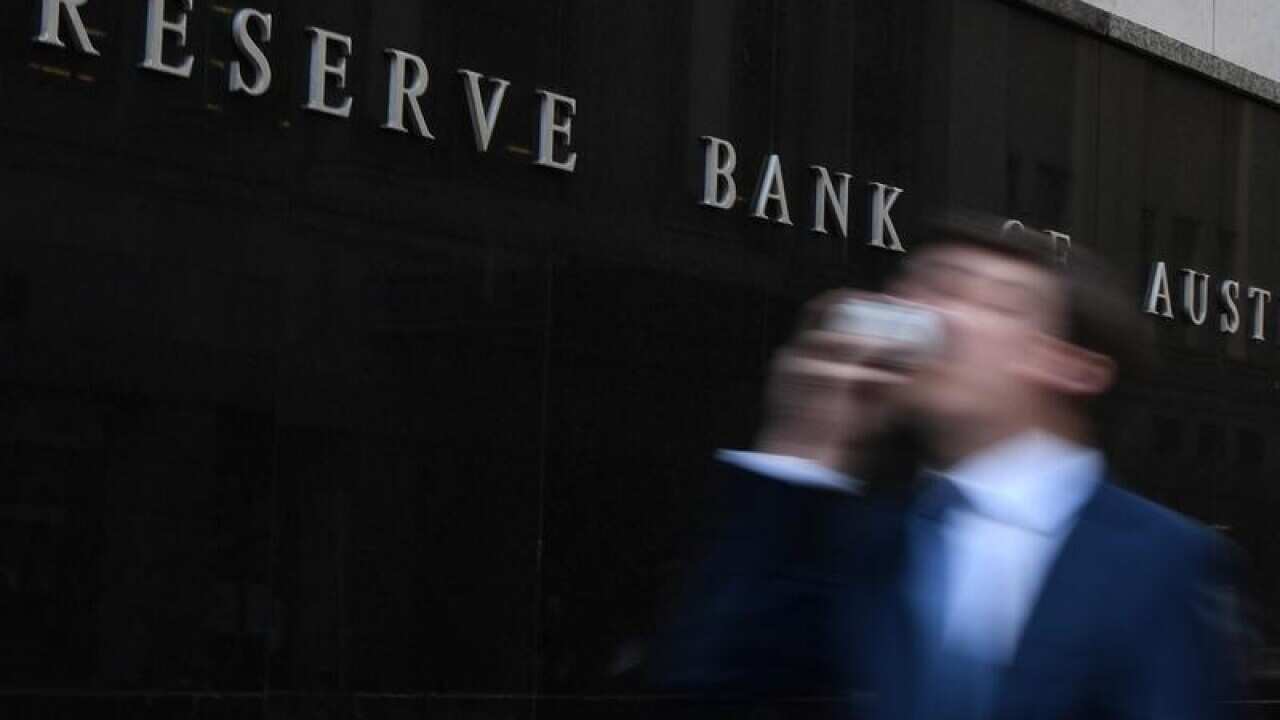 A man walks past the Reserve Bank of Australia building in Sydney.