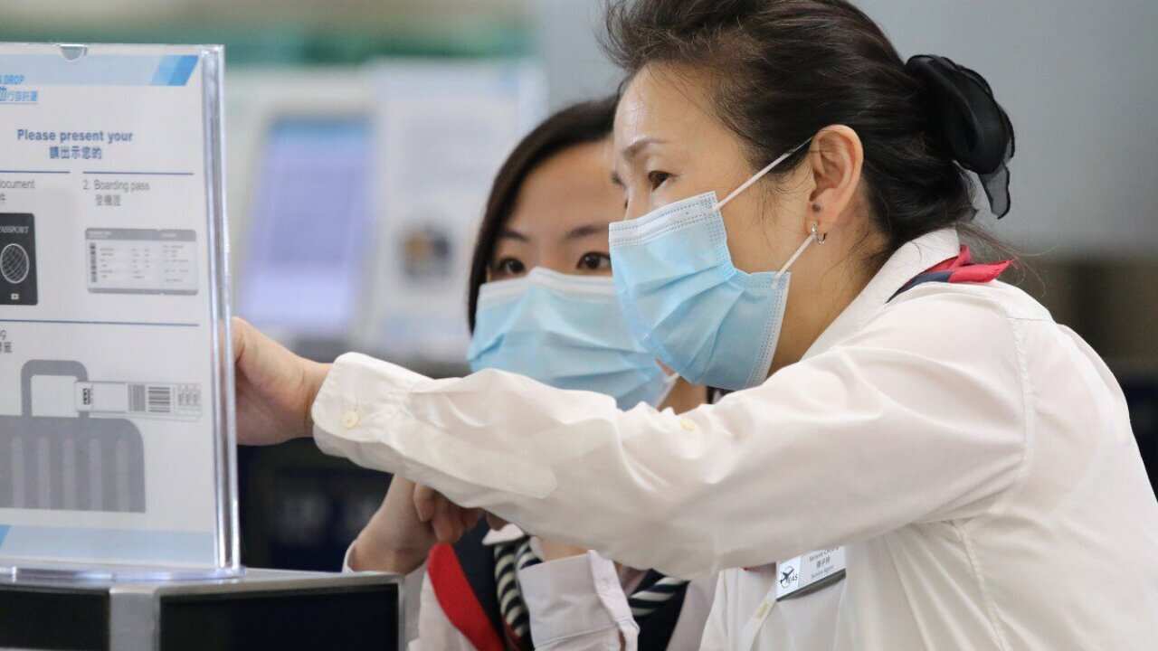 HK International Airport staffs wearing masks amid measles outbreak