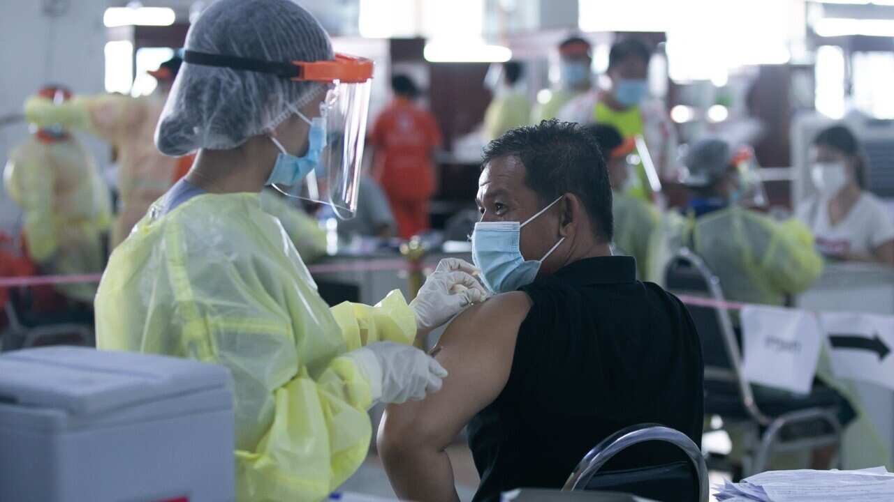 A man receives a dose COVID-19 vaccine at a vaccination center in Vientiane (Kaikeo Saiyasane - Xinhua via Getty Images)