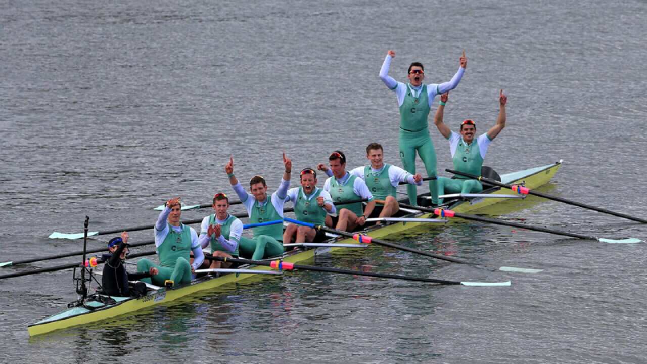 The Cambridge men's crew celebrate victory against Oxford men's crew