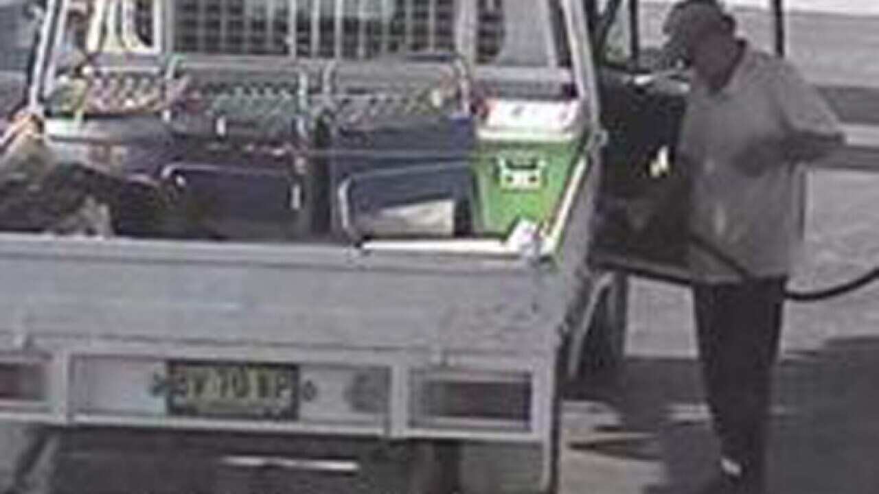 A supplied image obtained Thursday, Oct. 22, 2015 of a man believed to be one of two wanted fugitives, Gino Stocco or Mark Stocco, as they fill up their Toyota Landcruiser in country Victoria, north-east of Melbourne. (AAP Image/Victoria Police)
