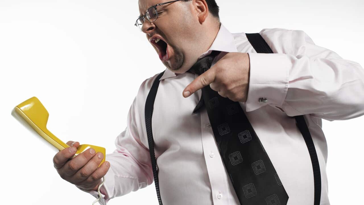 Businessman yelling swearing at phone