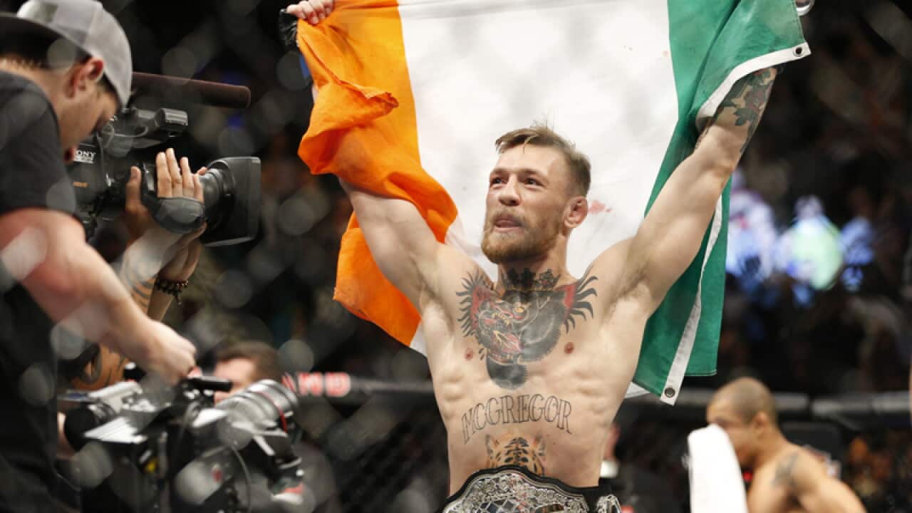 Conor McGregor reacts after defeating Jose Aldo