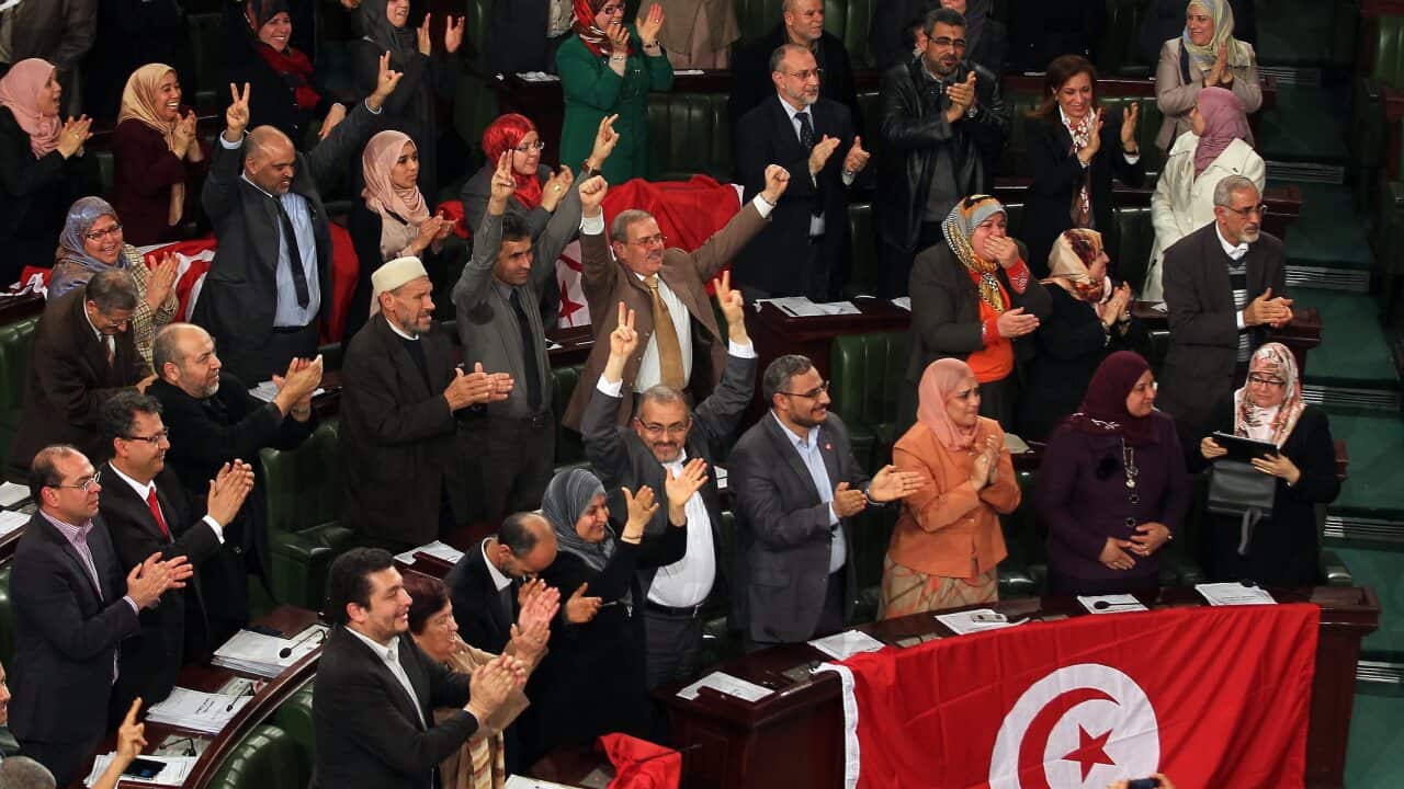 Members of the Tunisian National Assembly celebrate after the adoption of a new constitution - AAP-1.jpg