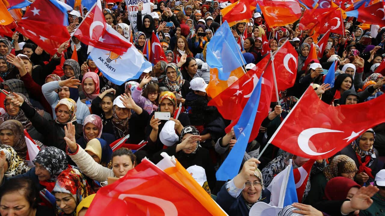 Supporters listen to Turkish Prime Minister Ahmet Davutoglu during a rally of his Justice and Development Party, or AKP
