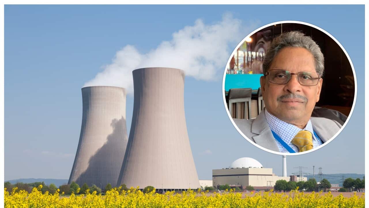 Nuclear power station with steaming cooling towers and blooming canola field. Location: Lower Saxony, Germany.