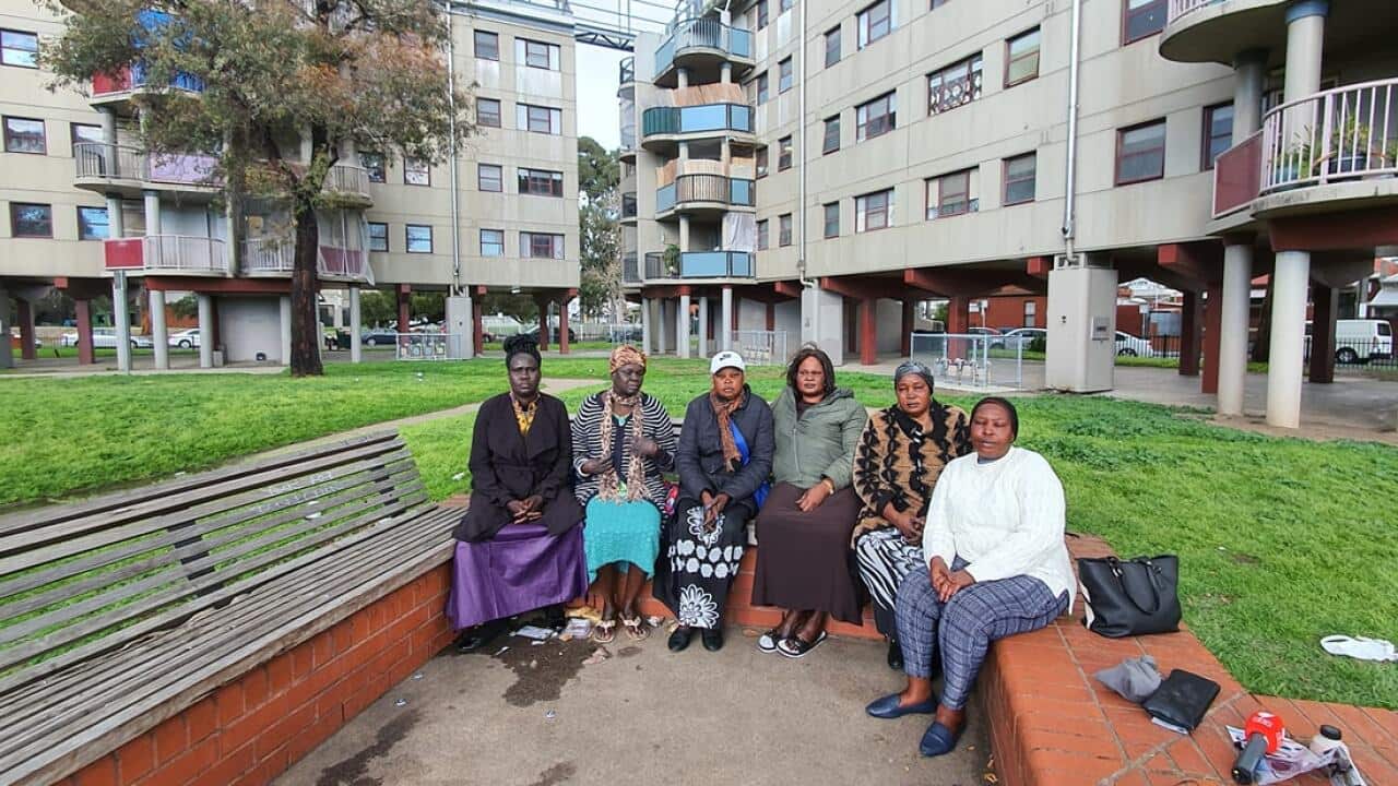 Mothers in a group photo in-front of the public Housing in Richmond