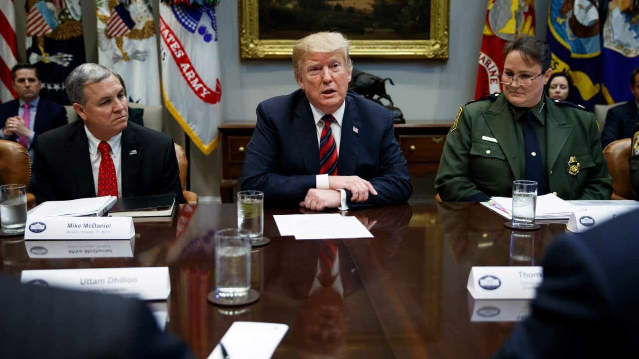 Mike McDaniel, director of Houston High Intensity Drug Trafficking Areas, left, and Carla Provost, chief of the U.S. Border Patrol, right, listen as President Donald Trump speaks in the Roosevelt Room of the White House