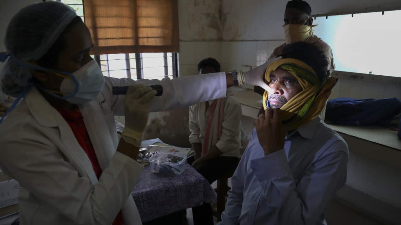 An Indian doctor checks black fungus infected patent at mucormycosis ward at a government hospital in Hyderabad, India.