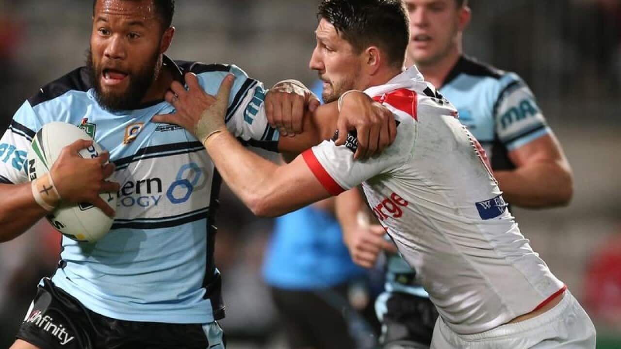 Gareth Widdop tackles Cronulla's Joseph Paulo.