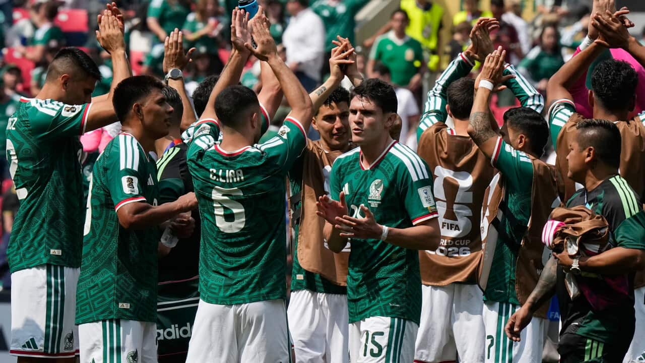 Mexican football players in national colours celebrating