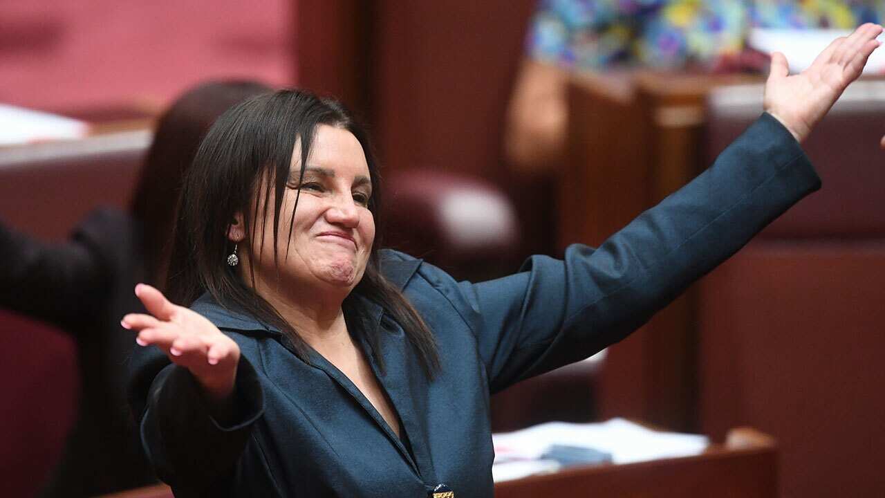 Tasmanian Senator Jacqui Lambie reacts after delivering a statement on her resignation in the Senate chamber at Parliament House in Canberra.
