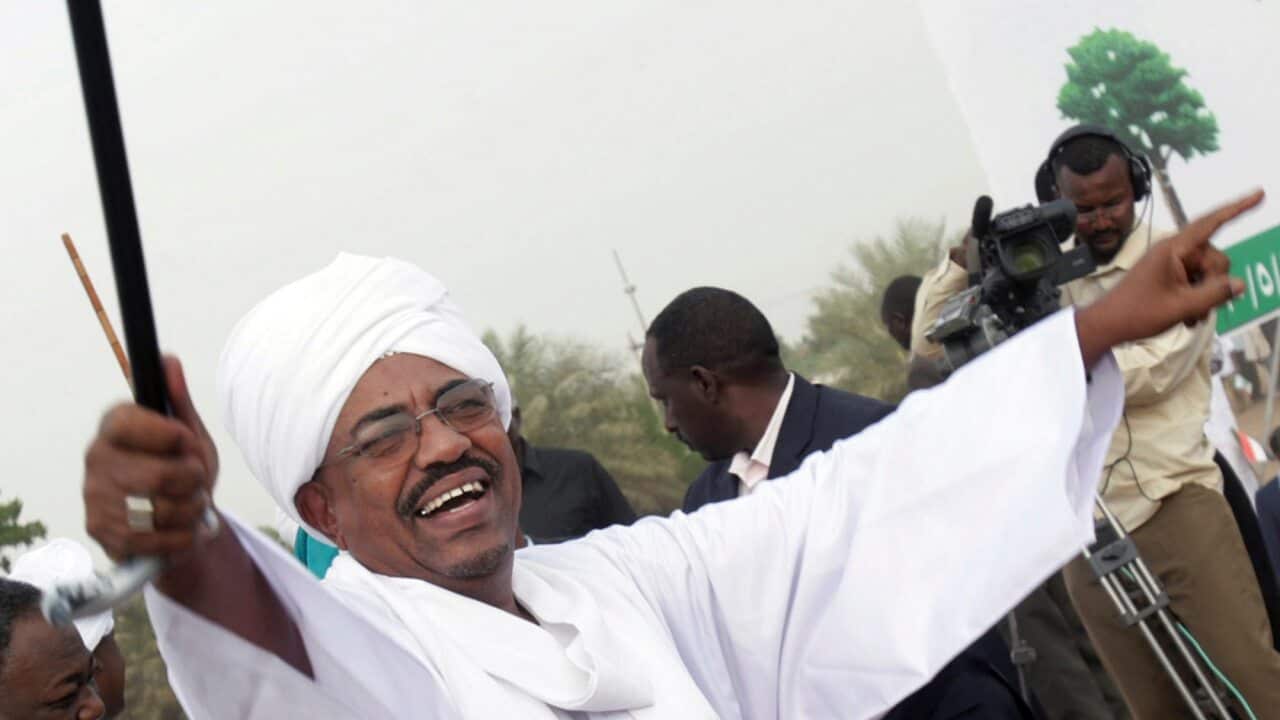 Sudanese President Omar al-Bashir greets his supporters during a rally at a fair in Khartoum, Sudan.