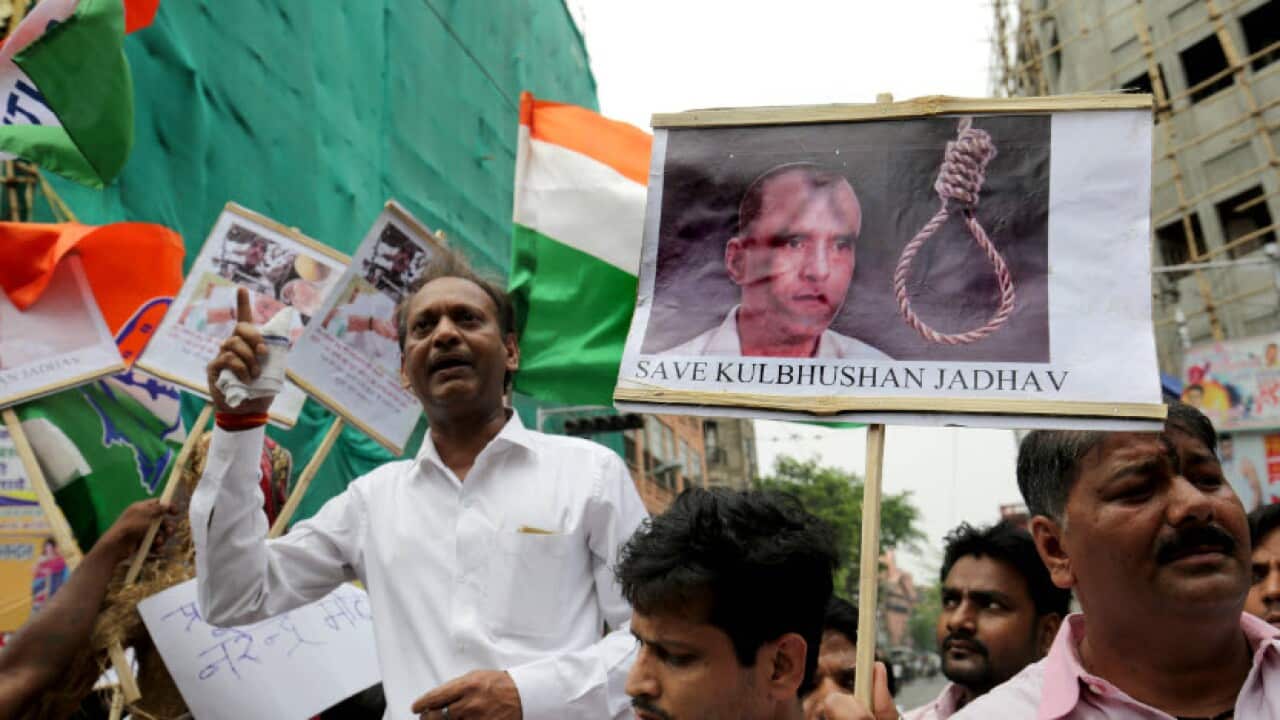 National Congress activists hold photographs of Indian national, Kulbhushan Jadhav, and placards against Prime Minister Narendra Modi in Calcutta, Eastern India