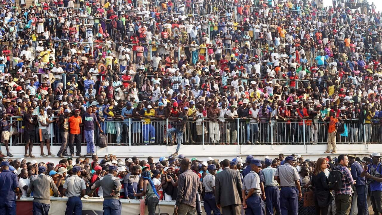 Crowds attend a funeral parade of the former Zimbabwean President Robert Mugabe at Rufaro Stadium in Harare