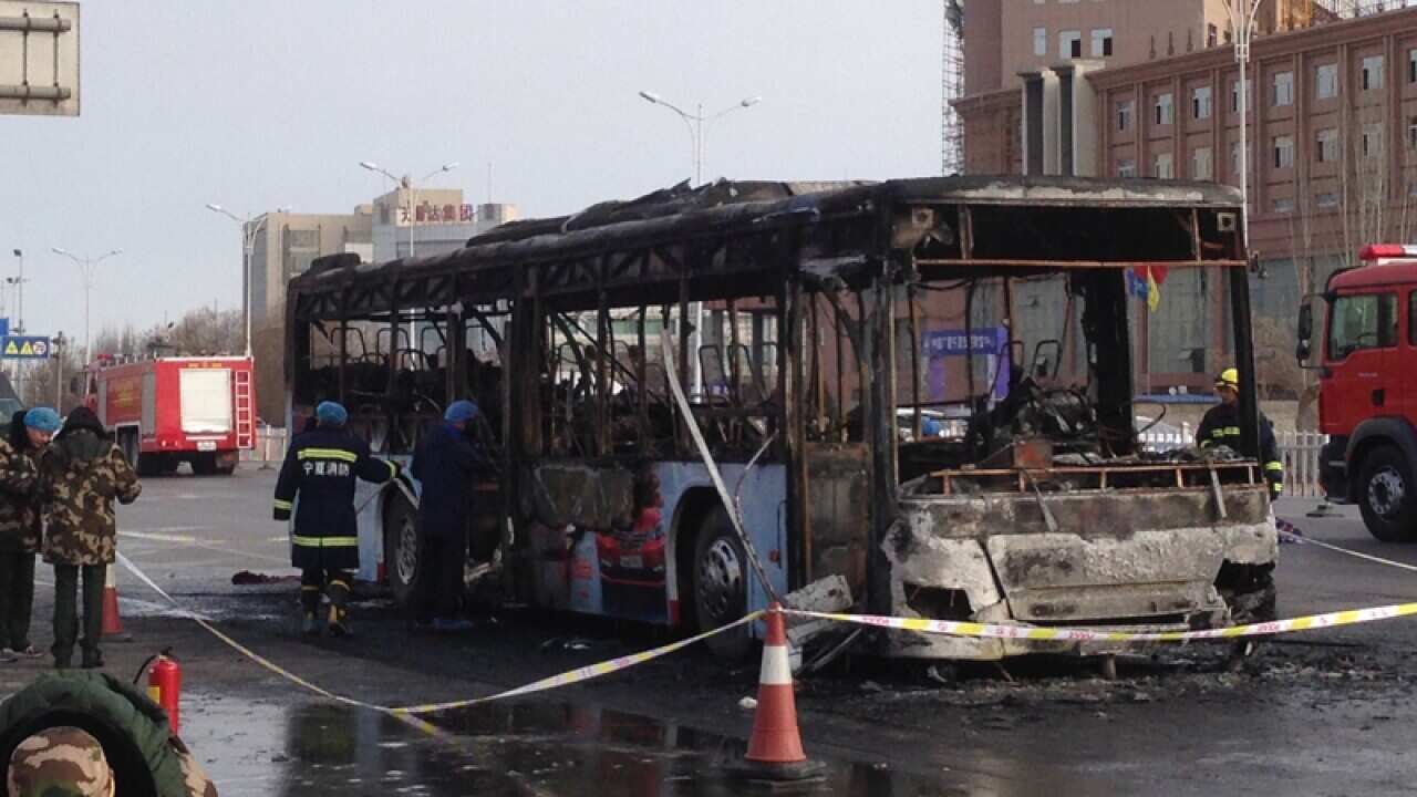 Firefighters work at an accident site of a bus fire in Yinchuan