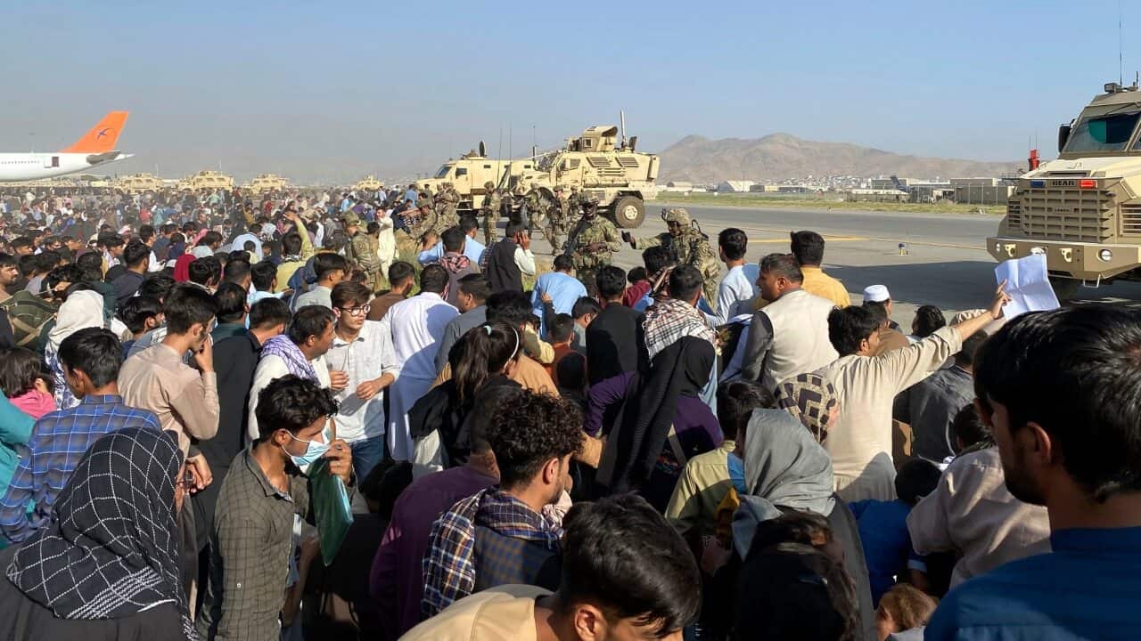 U.S soldiers stand guard along a perimeter at the international airport in Kabul