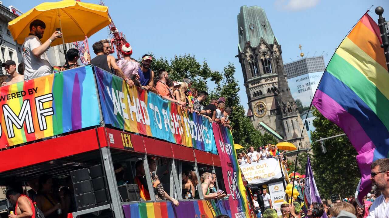 People participate in the 41th Christopher Street Day LGBT parade near the Berlin Memorial Church.