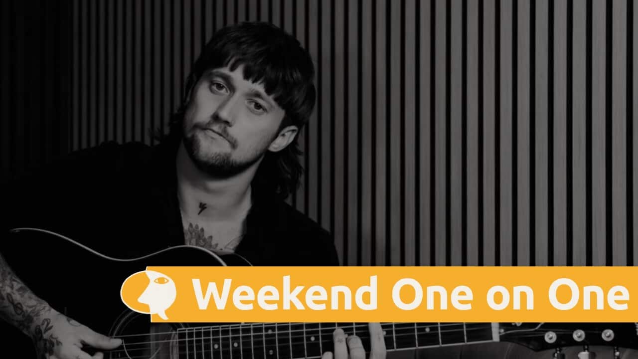 Musician Kalani Artis playing a guitar.