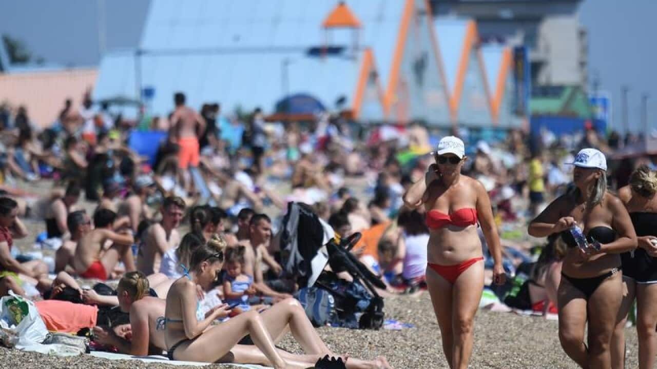 People enjoy the sunshine on the beach at Southend-On-Sea in Essex