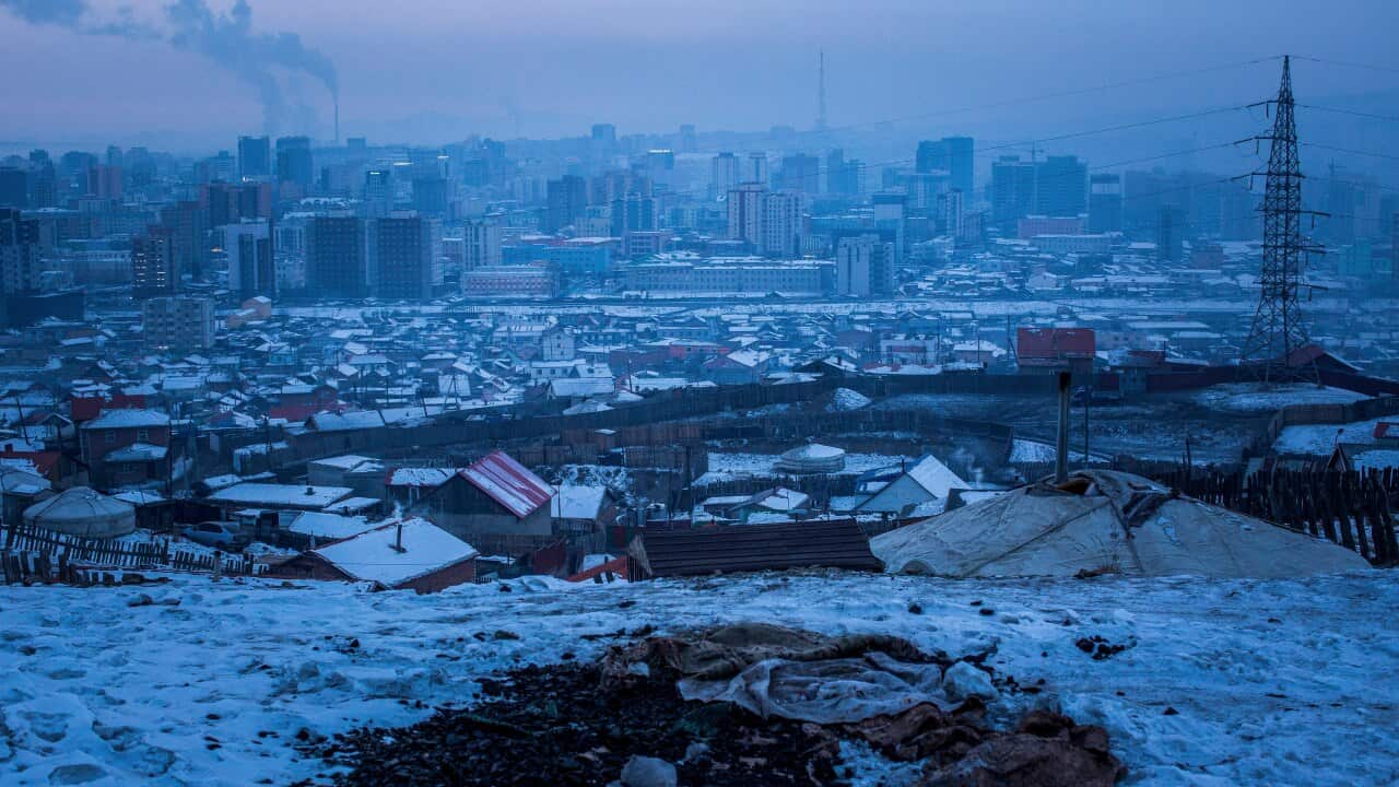 A pile of coal exposed in the snow on an abandoned lot in Ulaanbaatar, Mongolia.