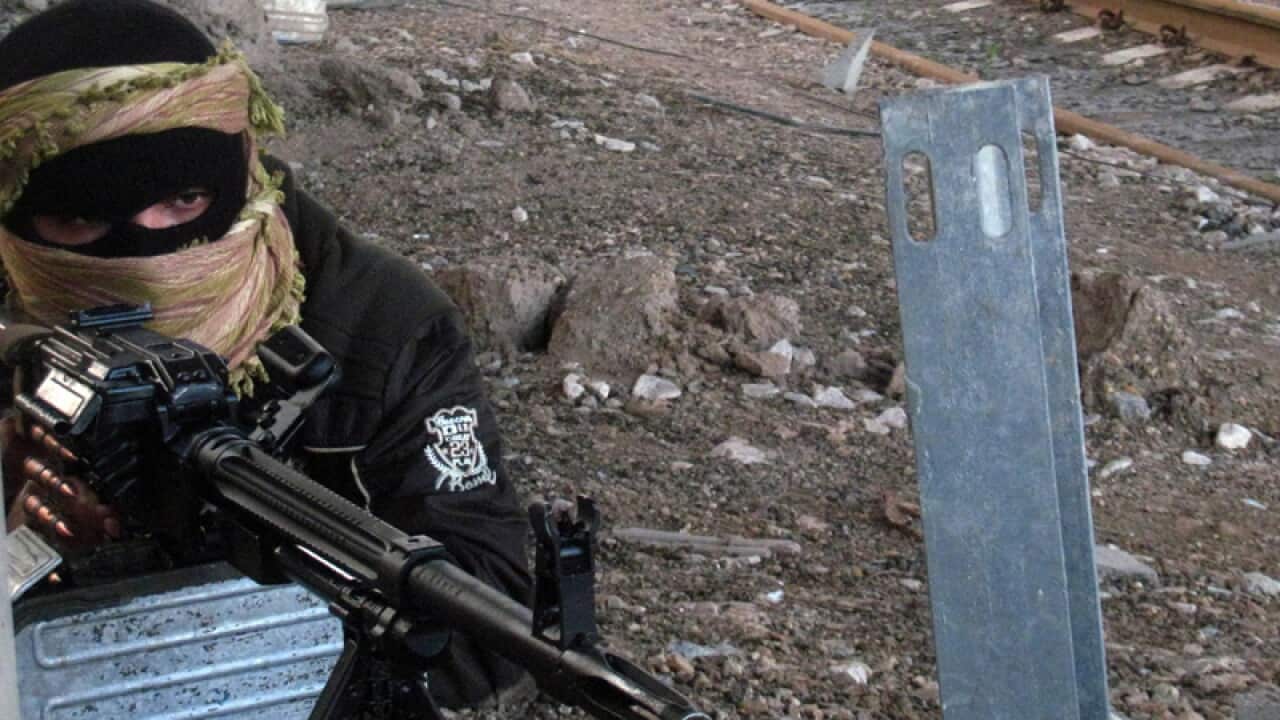 A Sunni fighter takes up position in Iraq