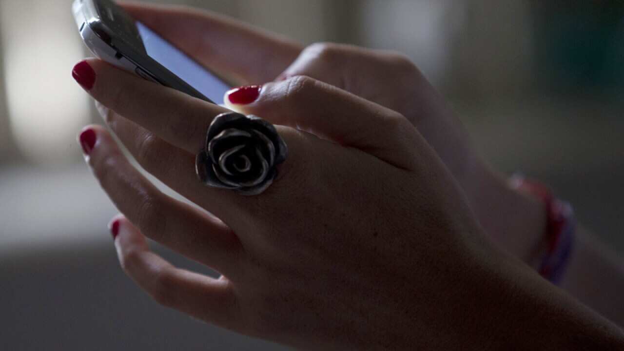 A woman uses her smartphone