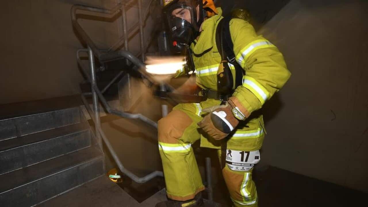 Firefighter wearing breathing equipment.