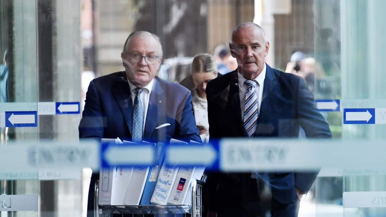 Two men in suits outside