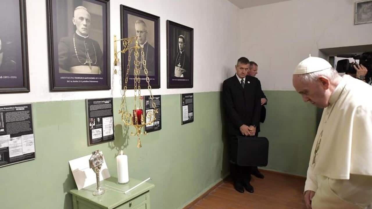 The Pope says a prayer at the Museum of Occupations and Freedom Fights
