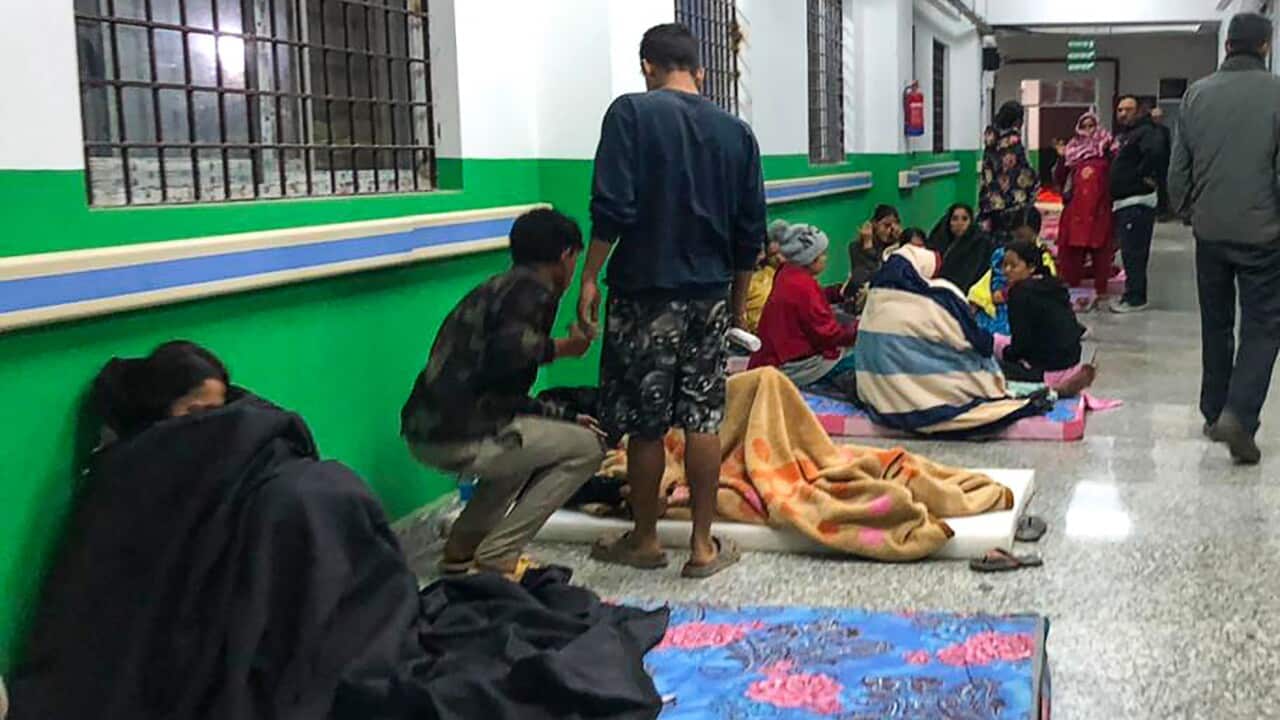 People sitting in a hospital corridor