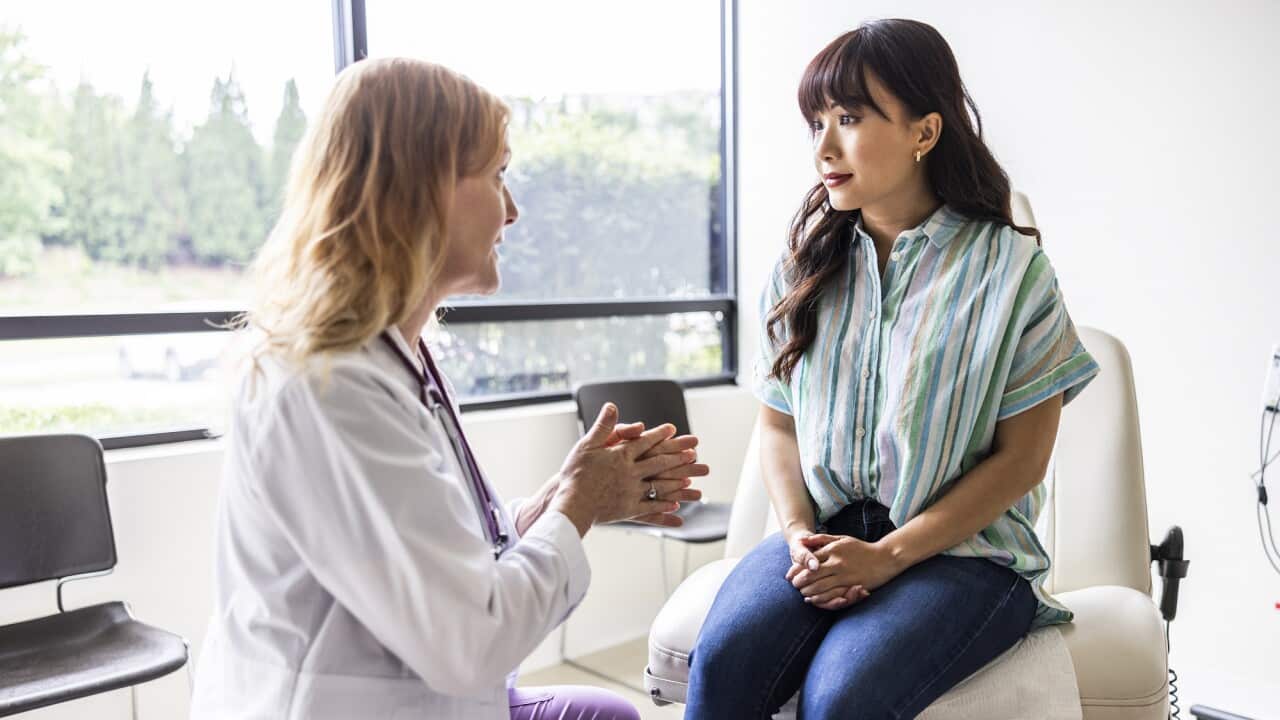 A female doctor talking to a female patient