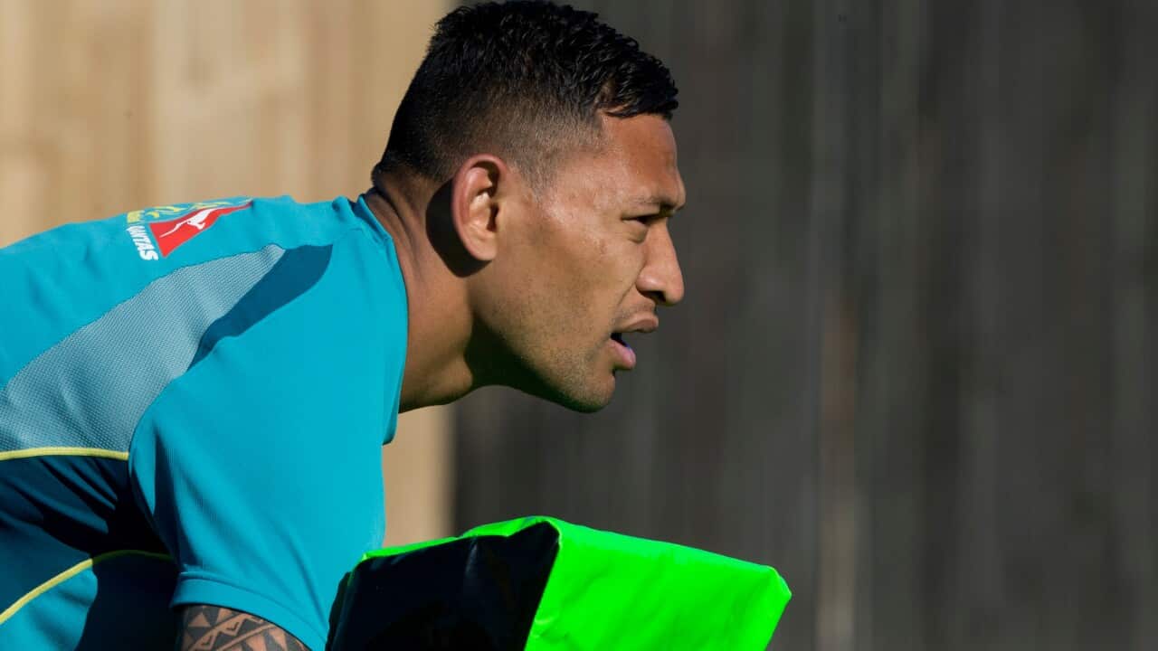 Israel Folau holds a tackle bag during a training session