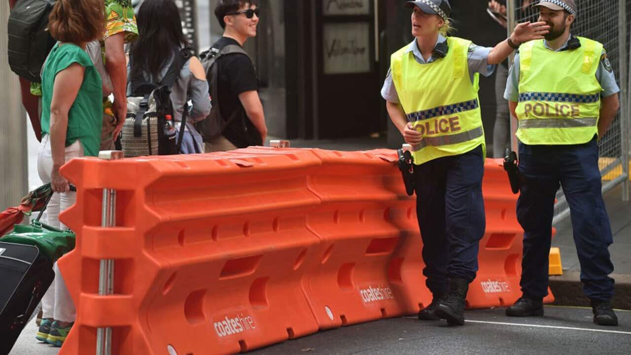Police give directions to visitors before the start of New Year's Eve celebrations in the central business district of Sydney on December 31, 2017.