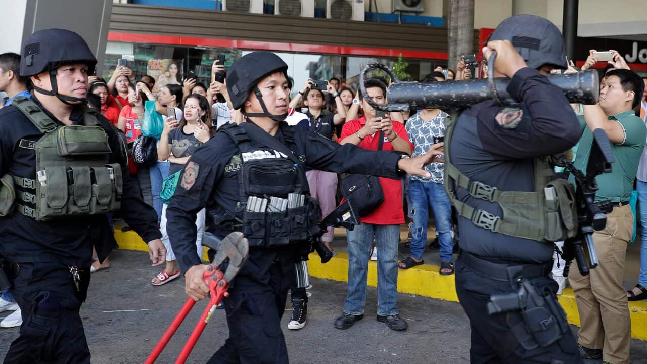 Police prepare to enter the mall in San Juan.