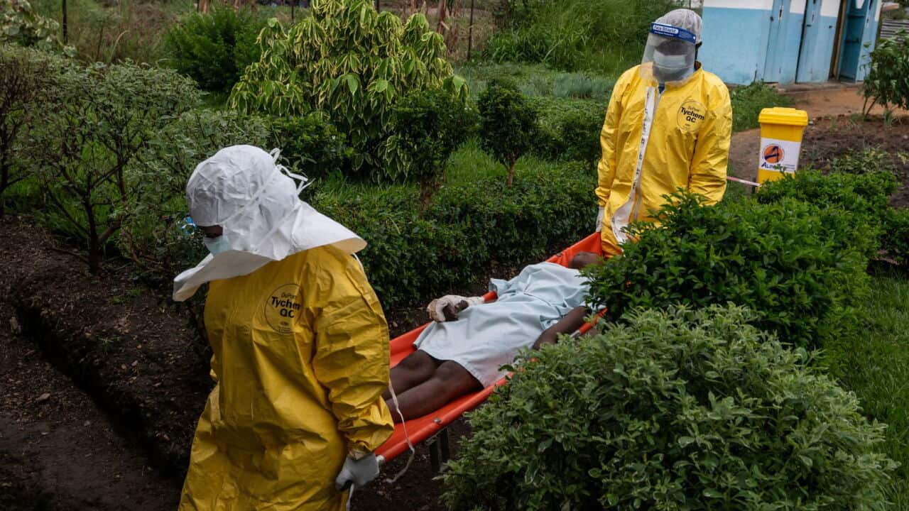 Medical staff carry an Ebola patient to a treatment centre in Rwampara, Congo (AP Photo-Moses Sawasawa).jpg