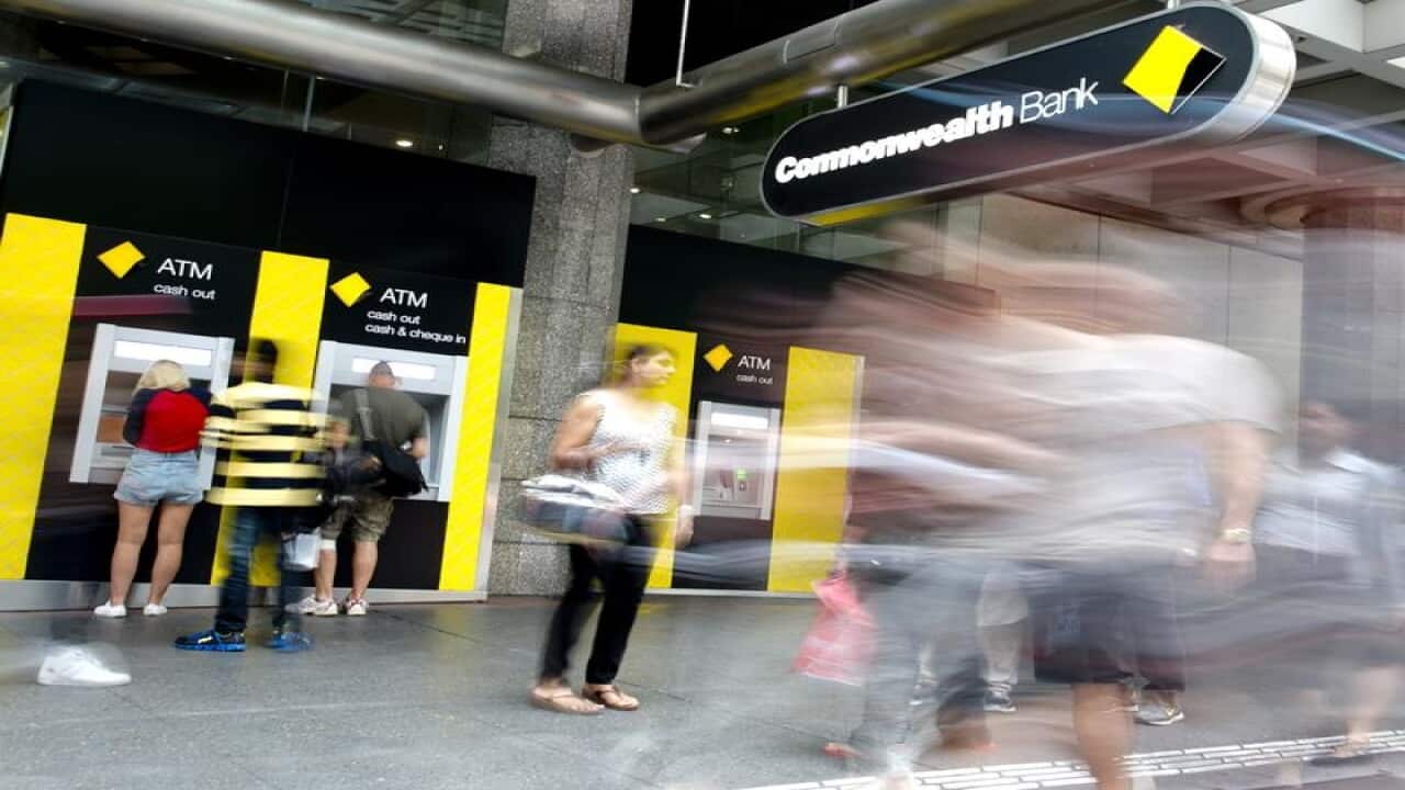 street scene showing people at CBA ATM