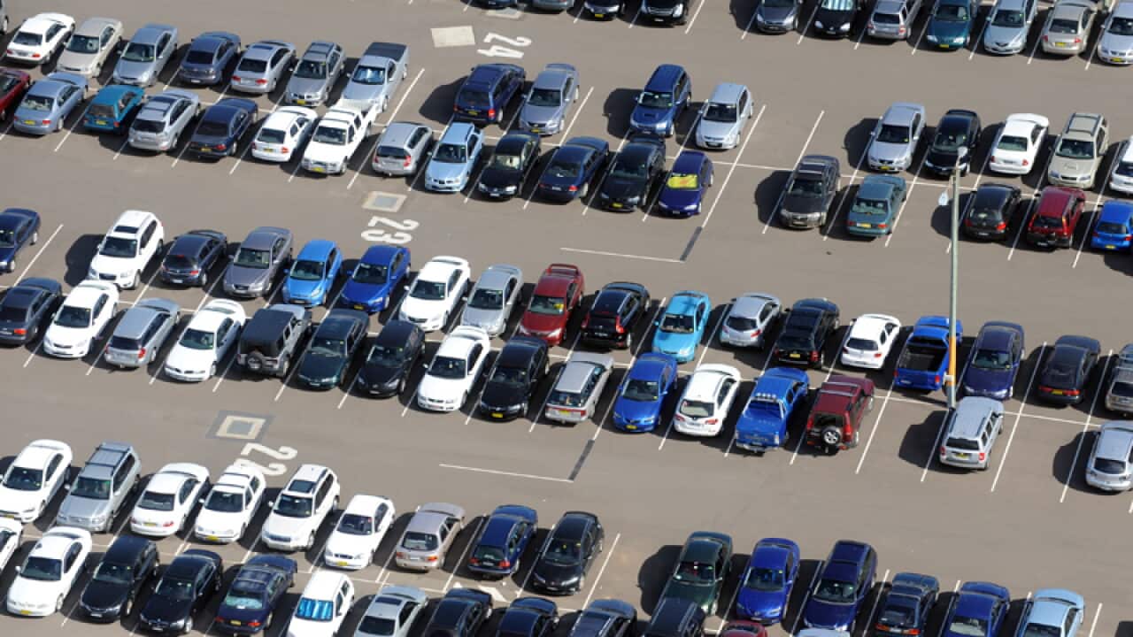 An aerial view of cars parked.