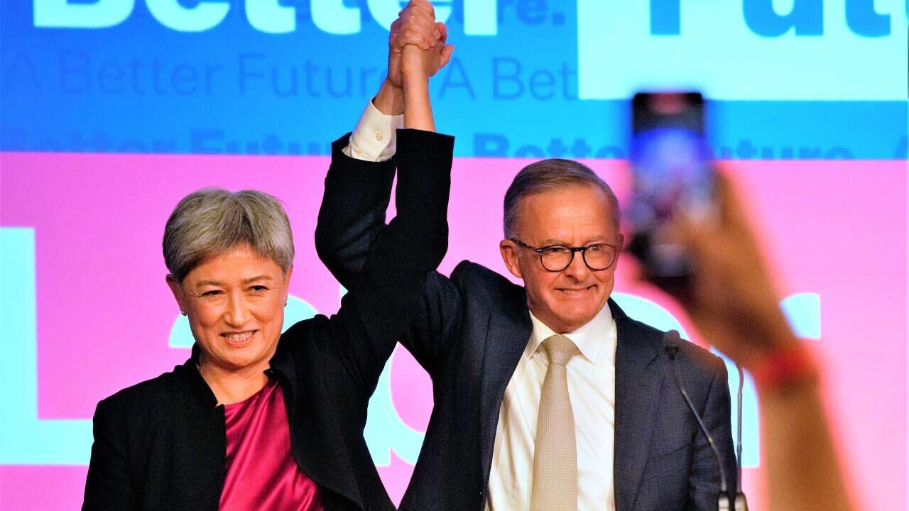 Labor Party leader Anthony Albanese, right, celebrates with Labor senator at a party event in Sydney, Australia, Sunday, May 22, 2022, after Prime Minister Scott Morrison conceding defeat to Albanese in a federal election. (AP Photo/Rick Rycroft)
