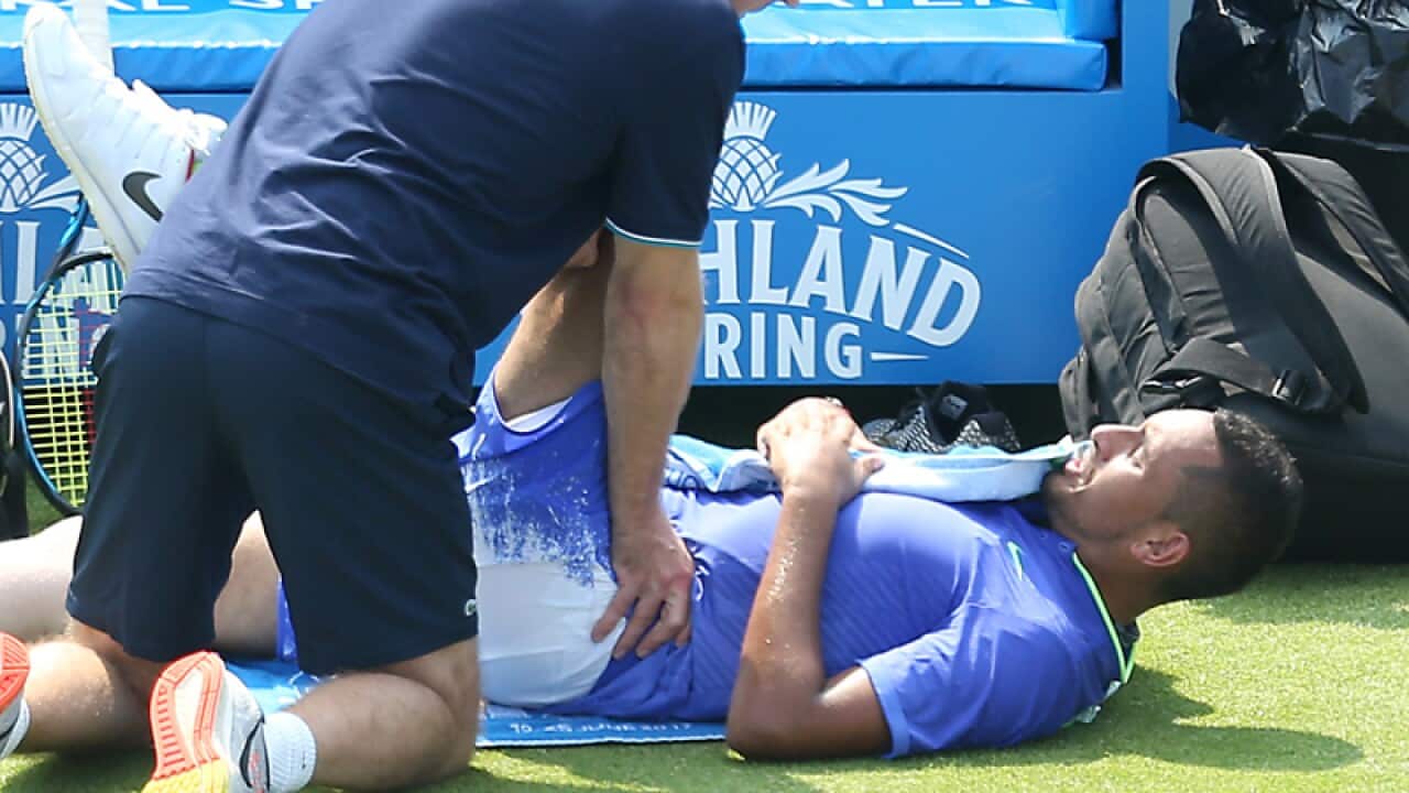 Nick Kyrgios receives medical treatment on court