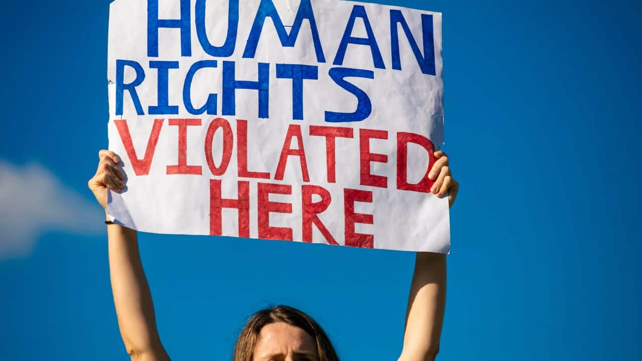 A refugee rights protester at the Kangaroo Point Central Hotel in Brisbane, Sunday, June 21, 2020.