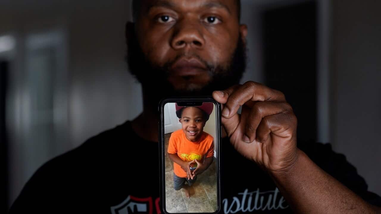 Leon Abdullah El-Alamin shows a photo of his son Leon Jr